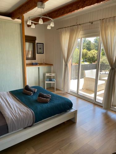 a bedroom with a large bed and a large sliding glass door at Résidence Le Golfe Bleu in Rayol-Canadel-sur-Mer