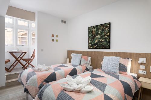 two beds sitting next to each other in a room at Blue Hues Apartments in Il-Ħamra