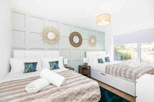 a bedroom with two beds and a window at Luxury SeaWay sleeps 12, playroom/xbox in Barton on Sea
