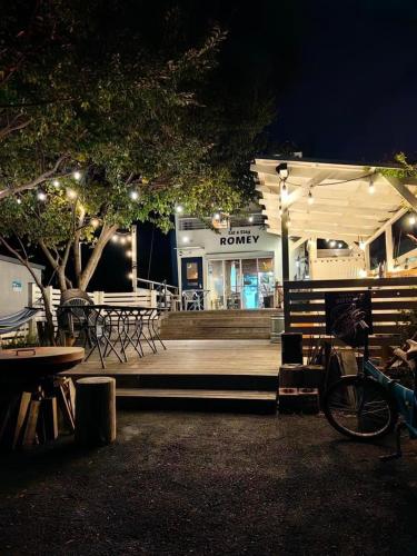 a restaurant with tables and chairs at night at 富士山も見える静かな港町用宗のオーシャンビューゲストハウスRomey in Shizuoka