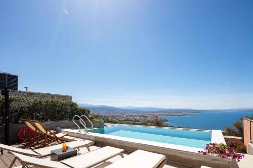 a swimming pool with a view of the water at Omnia Luxury Villas in Chania Town
