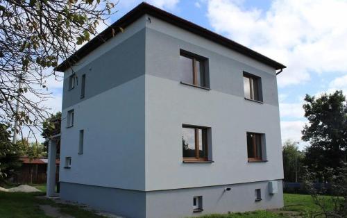 a white house with windows on the side of it at Apartament u Jędrusia in Żywiec