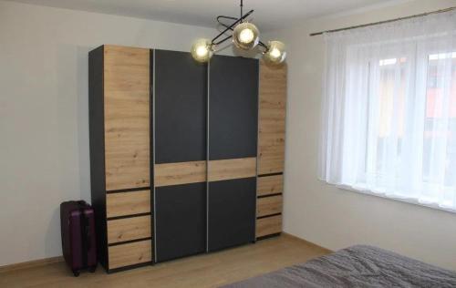 a bedroom with a large cabinet in the corner of a room at Apartament u Jędrusia in Żywiec