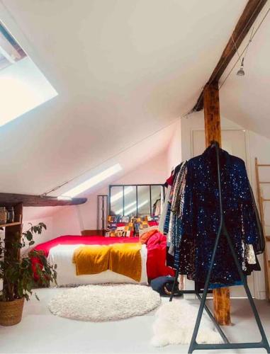 a bedroom with a bed in a attic at Superbe duplex loft au coeur de Paris in Paris