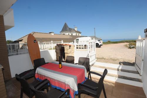 a table and chairs on the back porch of a house at Vivenda Sol E Mar in Baleal