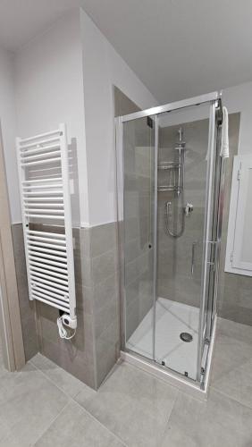 a shower with a glass door in a bathroom at Residenza Novi in Novi Ligure