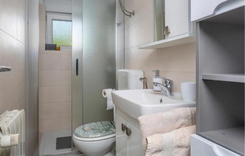 a small bathroom with a sink and a toilet at Stunning Apartment In Krk With Kitchen in Krk