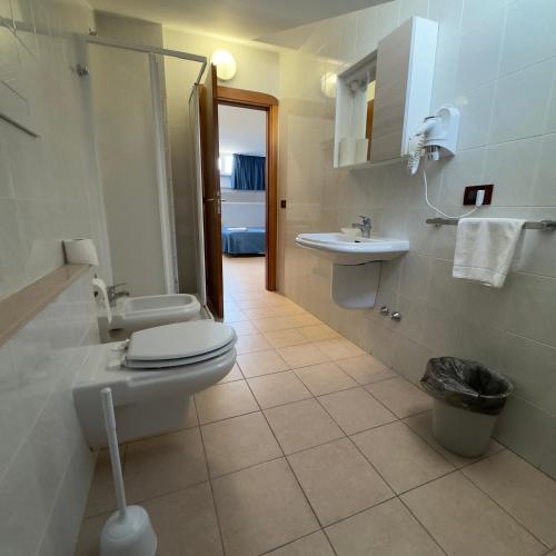 a bathroom with a toilet and a sink at Hotel Immagine in San Giovanni Rotondo