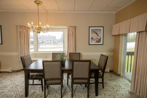 a dining room with a table and chairs and a window at Peek'n Peak Resort Trademark Collection by Wyndham in Clymer
