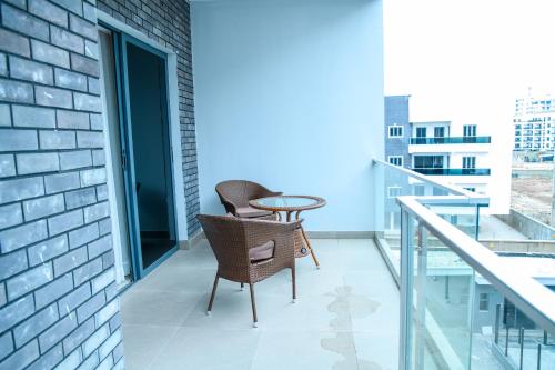 a balcony with two chairs and a table at Elim Maisonette in Lekki