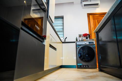 a washer and dryer in a small kitchen at Elim Maisonette in Lekki