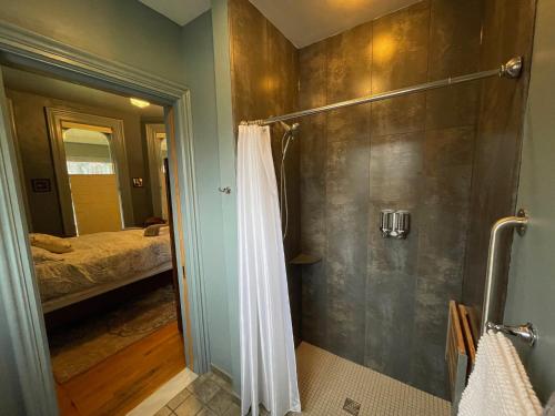 a bathroom with a shower with a shower curtain at Oscar's Inn in Buffalo