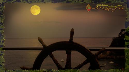 a wooden steering wheel with the moon in the background at Villa Arianna B&B in Taormina
