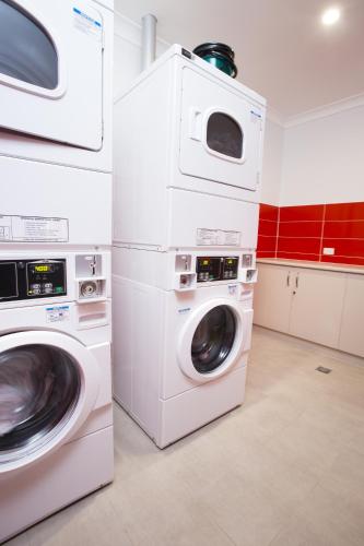 a laundry room with two washer and dryer at Altitude Motel Apartments in Toowoomba