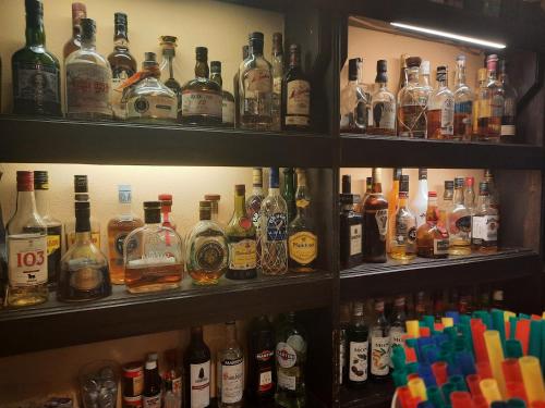 a shelf filled with lots of bottles of alcohol at Hotel Arte Vida OHG in Spremberg