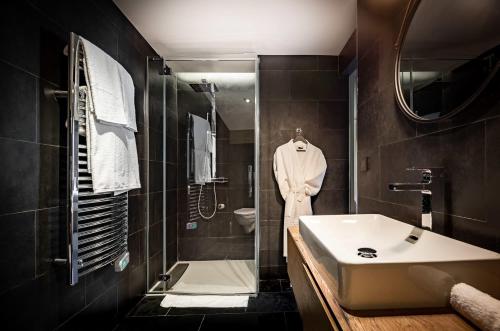 a bathroom with a sink and a shower and a toilet at Chalet Virolo in Megève