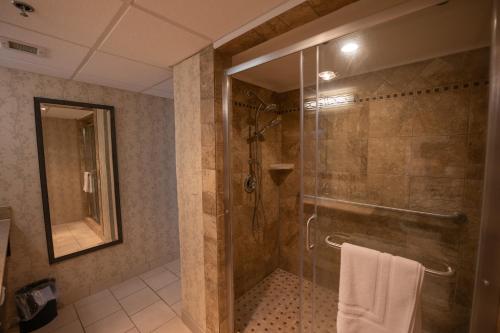 a bathroom with a shower with a glass door at Peek'n Peak Resort Trademark Collection by Wyndham in Clymer