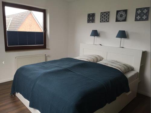 Ένα ή περισσότερα κρεβάτια σε δωμάτιο στο Ferienwohnung Familie Ossenbühl