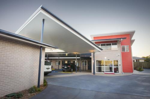 a garage with a car parked in a parking lot at Altitude Motel Apartments in Toowoomba