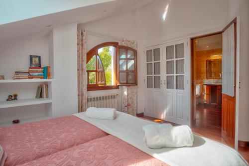 een slaapkamer met een groot bed en een raam bij Casa La Serena in Lusa