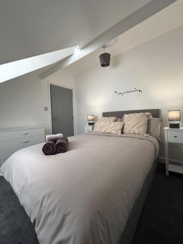 a bedroom with a large white bed in a room at Rock Park Penthouse in Llandrindod Wells