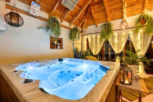 a jacuzzi tub in a room with plants at 4 bedrooms villa with private pool jacuzzi and enclosed garden at Turcin in Črnec Biškupečki