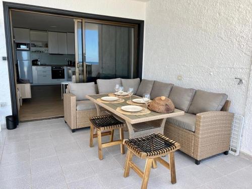 a living room with a couch and a table at Stunning cliffs and ocean view in Los Gigantes in Acantilado de los Gigantes