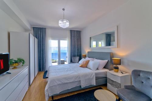 a bedroom with a large bed and a tv at Apartments Maria in Senj
