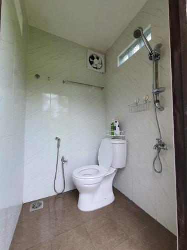 a bathroom with a toilet and a shower at Teratak D Tuntung, Hulu Langat in Kampong Mesjid