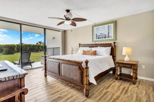 a bedroom with a bed and a ceiling fan at Cape Winds Resort in Cape Canaveral