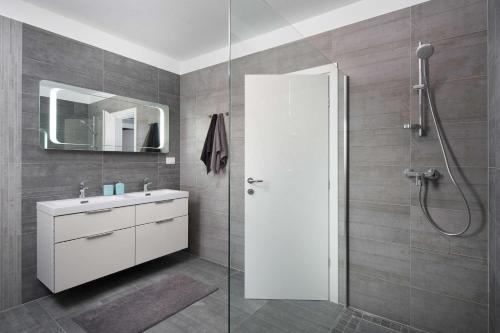 a bathroom with a white sink and a shower at Villa Fabiana, a luxurious and spacious villa, few minutes from the beach in Labin