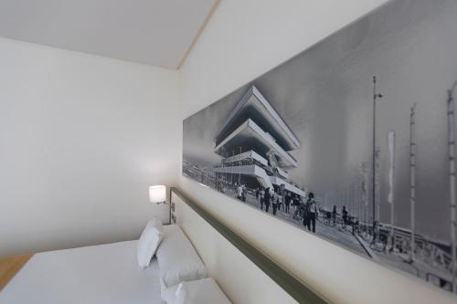 a black and white picture of a building on a wall at Primus Valencia in Valencia