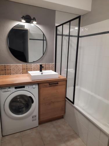 La salle de bains est pourvue d'un lave-linge et d'un miroir. dans l'établissement La Maison de Nat, à Nyons