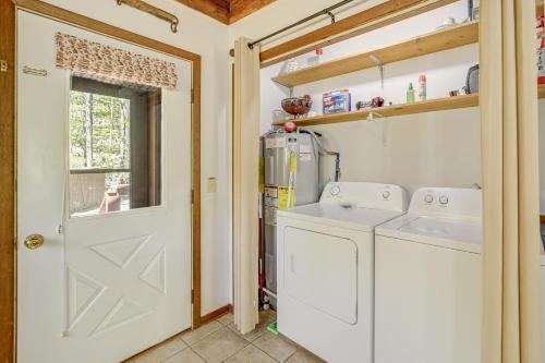 a laundry room with a washer and dryer at Creekside Cabin with Deck and Grill in Whittier! in Whittier