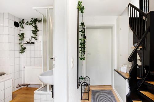 a small white bathroom with a sink and a staircase at M B Homes in Balzholz