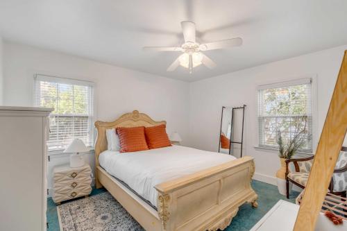 a bedroom with a bed and a ceiling fan at The Oyster House Downtown in Charleston
