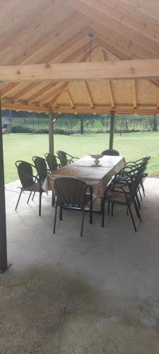 a table and chairs under a wooden pavilion at Vikendica Štira in Loznica