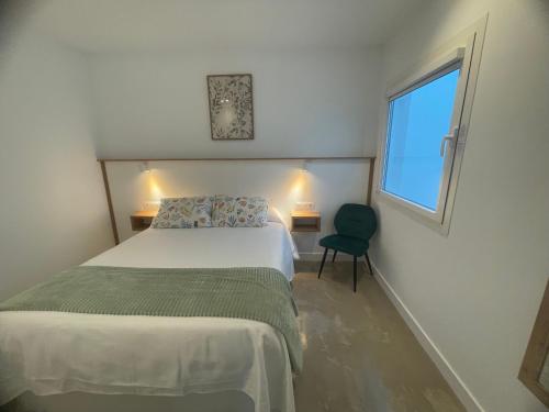 a bedroom with a bed and a window and a chair at Ventana del Nublo 2-I in Tejeda