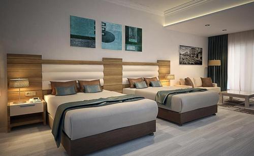 a hotel room with two beds and a couch at LİMAN OTEL in Istanbul