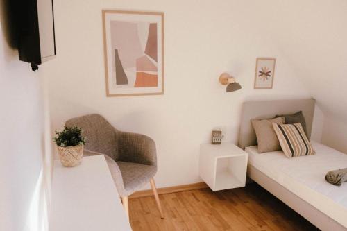 a living room with a couch and a chair at Bantle Pension Gästehaus Ravensburg in Ravensburg