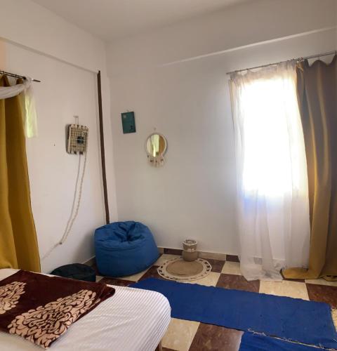 a bedroom with a bed and a window at The Way Hostel double Room in Dahab