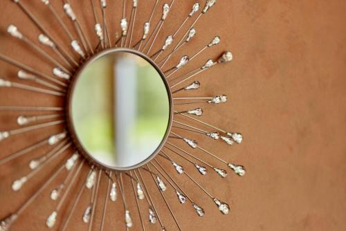 a mirror on top of a brown wall at Cafe Rosi in Bernkastel-Kues
