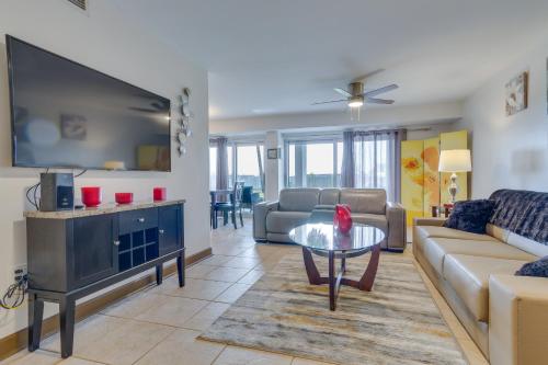 a living room with a large flat screen tv at Pensacola Beach Condo with Patio and Access to Beach! in Pensacola Beach