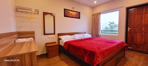 a bedroom with a bed and a mirror and a window at Sky High Villa Annex in Kodaikānāl