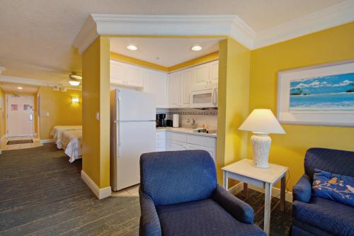 a hotel room with a kitchen and a living room at Direct oceanfront, fantastic ocean view, separate bedroom ! - Pools open ! in Daytona Beach