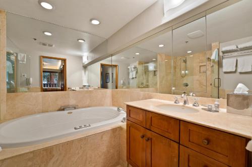 a large bathroom with a tub and a sink at Bridge Street - Unit 202 in Vail