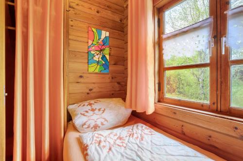 a bedroom with a window and a bed and a pillow at Hüssli Numero 1 in Hayingen