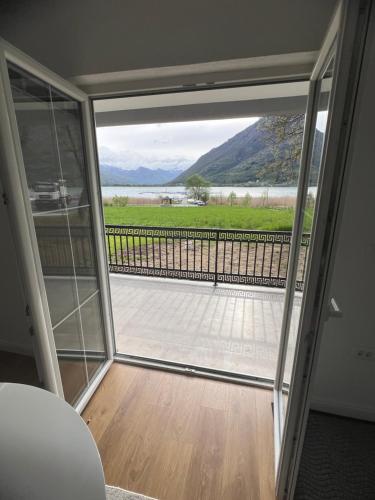 a sliding glass door with a view of a balcony at Saraapartmani in Plav