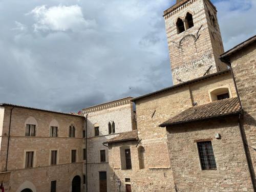 a large stone building with a clock tower at Camere di Bianca in Foligno