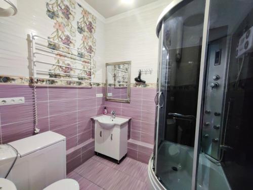 キーウにあるGreat Apartment in Smart Plaza KPIの紫色のバスルーム(トイレ、シンク付)